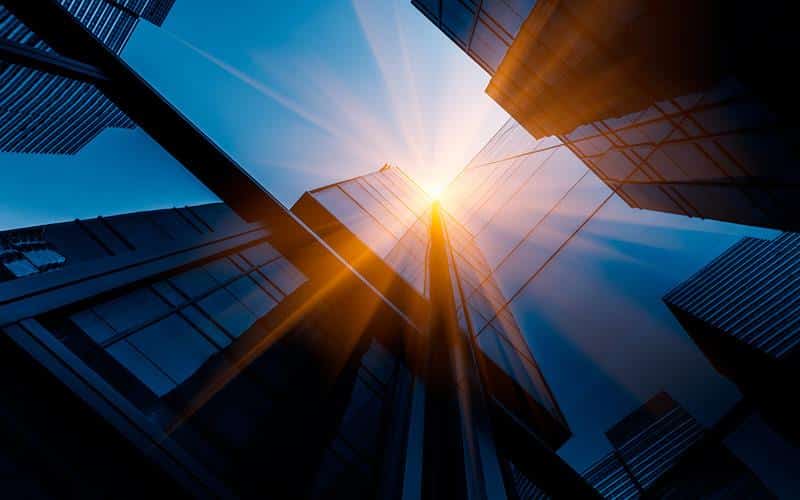 Commercial Glass - sun shining between skyscrapers