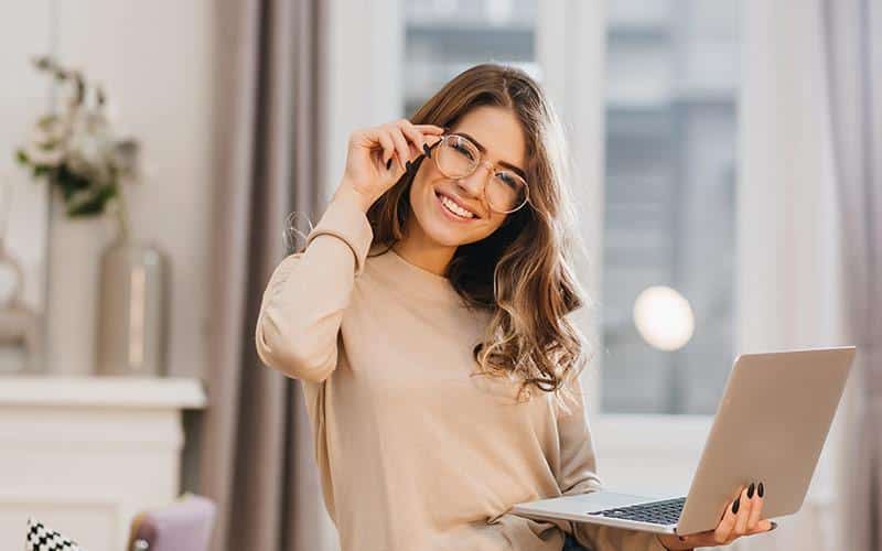 Optics Technologies - Girl with glasses holding a laptop